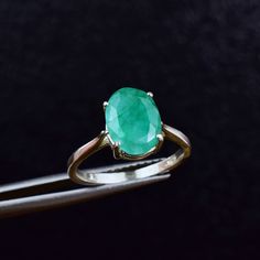 "Genuine Colombian Emerald Solitaire Ring * This is a stunning, high quality Rustic Emerald gemstone with vivid green colors. Set in a high-profile prong setting so that light comes in from every angle to fully accentuate the true beauty of this stone. A true eye- catcher noticeable from across the room. * Please allow 7-10 days processing time for Sterling Silver Option of this ring. Please allow 2-3 weeks processing time for 14k Gold Option as your ring will be specially made for you. EMERALD Oval Solitaire Ring, Emerald Solitaire Ring, Green Gemstone Ring, Precious Stones Rings, Green Ring, Green Rings, Emerald Pendant, Colombian Emeralds, Oval Ring