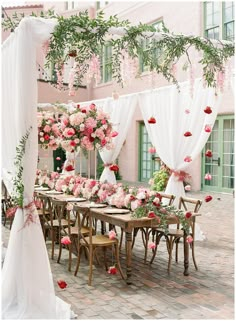 an outdoor wedding setup with pink flowers and greenery