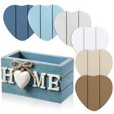 a wooden box with the word home painted on it and five heart shaped pieces in different colors