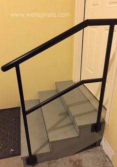 a set of stairs with handrails in front of a door and carpet on the floor