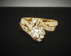 14K Yellow Gold Diamond Engagement / Wedding Set, Size 4 3/4. Rings weigh a total of 3.2 dwt. (1) Center Diamond: 0.66ct, clarity SI1, color I-J, Round Brilliant Cut. (6) Six Diamonds: 0.03ct, Round Brilliant Cut, clarity VS1-SI1, color H-I. (14) Fourteen 0.01-0.03ct Baguette Cut Diamonds, clarity VVS2, color H-I. This diamond wedding set has been appraised for a replacement value of $3,800.00. Appraisal can be seen in the photos. All carat diamond weights, clarity, and color are approximate bec Gia Certified Yellow Gold Diamond Ring For Wedding, 14k Stamped Diamond Wedding Ring, Stamped 14k Diamond Wedding Jewelry, Gia Certified Yellow Gold Wedding Jewelry, Gia Certified Gold Wedding Jewelry, Diamond Wedding Sets, Baguette Cut Diamond, Shop Owner, Wedding Set