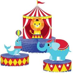 an elephant and two elephants in front of a circus tent with a lion on top