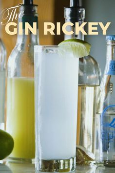 the gin rickey cocktail is ready to be served with limes and lemonade