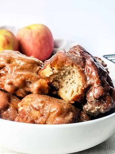 a white bowl filled with donuts and apples