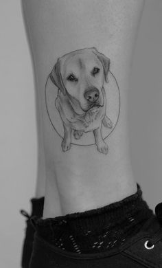 a black and white photo of a dog's face on the ankle with a circle around it