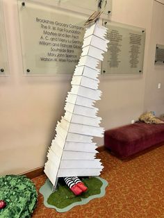 a very tall paper christmas tree sitting on the floor