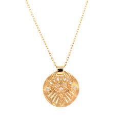 This 14kt yellow gold necklace is a true one of a kind treasure, featuring an all seeing eye design with hand engraved details on a medallion coin pendant. A round diamond set in the center of a marquise shape eye hangs in the center of the design and is surrounded by a sprinkle of white baguette and round diamonds. The pendant has such flattering movement complete with a wide solid gold bail that slides along a chain measuring 20" total length. Designer: Celine Daoust, handmade in Brussels. 14k Gold Amulet Medallion Jewelry, Symbolic Diamond Medallion Necklace, Diamond Coin Pendant Medallion Jewelry, Symbolic Diamond Round Pendant Necklace, Symbolic Diamond Necklace With Round Pendant, Symbolic Round Pendant Diamond Necklace, Fine Jewelry Necklace With Coin Medallion, Fine Jewelry Necklace With Coin Pendant, Fine Jewelry Medallion Necklace With Large Pendant