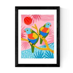 two colorful birds perched on a tree branch in front of the sun and palm trees