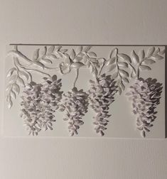 some white flowers are hanging on the wall and there is no image in it to describe