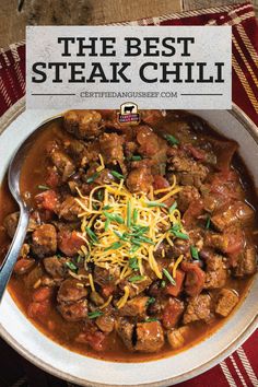 the best steak chili recipe in a white bowl with a spoon and napkin on top