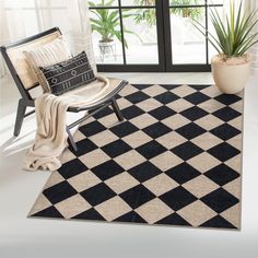 a black and white checkered rug with a chair next to it in front of a window