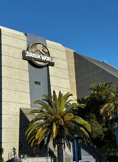 there is a large building that has a dinosaur world sign on it's side