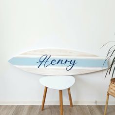 a wooden surfboard with the word henry on it