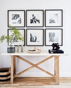 a white table topped with pictures and vases