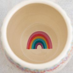 a white bowl with a rainbow painted on it