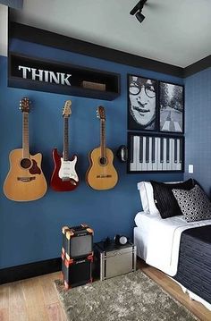 a bedroom with blue walls and guitars on the wall