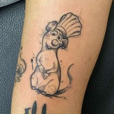 a cartoon mouse tattoo on the leg