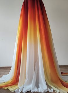 an orange, yellow and white dress is on display