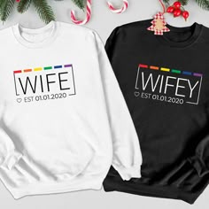 two sweatshirts with the words wife and husband on them next to candy canes