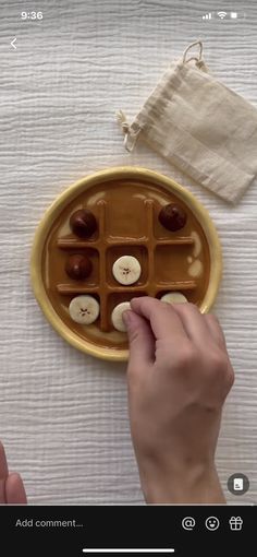 someone is placing buttons on a chocolate plate