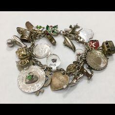 925 Sterling Silver Charm Bracelet W/ Florida, Crew Ship, And Airplane Featured Charms: Clog, Green And Red Holly Leaf, Sneaker, Daughters Of The Nile (Dofn), Florida, Happy Birthday, Bowling Pin And Ball, Motor Cycle, Virgin Islands, "To The Dearest Mother" W/Green Gem Stone, Cross W/7, Heart Charm W/ "Robin", "Touch Wood", Diving Charm, Mickey, Wine Glass, Cable Car, Dog, Masonic Charm, My Valentine, Airplane, Crew Ship, Girl W/Ponytail Good Condition: W/Slight Tarnish Collectible Sterling Silver Bracelet, Unique Sterling Silver Jubilee Bracelet, Heirloom Silver Bracelet With Vintage Charm, Silver Heirloom Jewelry With Vintage Charm, Heirloom Silver Jewelry With Vintage Charm, Heirloom Style Silver Metal Bracelets, Silver Charm Bracelet For Formal Occasions, Silver Charms Costume Jewelry, Heirloom Style Sterling Silver Bracelets In Silver