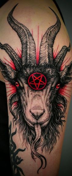 a goat with horns and pentagramus on it's head is shown in this tattoo