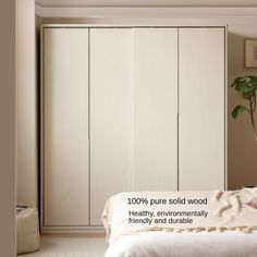 a bedroom with white closets and a plant on the bed in front of it that says 100 % pure solid wood healthy, environmental friendly and durable