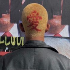 the back of a man's head with red ink on his forehead and face