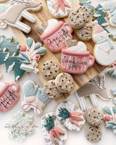 decorated cookies are sitting on a cutting board