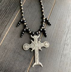 This beautiful, one-of-a-kind pewter ornate cross necklace will inspire all your moonlit nights. Handmade with black agate and glass beads. Measures 18 inches long and has a 2 inch extender chain. product details silver tone metals; Cross is soft pewter. 18 inches long with 2 inch extender black agate and glass beads VISIT MY SHOPS HERE * http://www.etsy.com/shop/HappyCatHouse * http://www.Etsy.com/shop/AnEnchantingCreature CONNECT * http://www.facebook.com/EnchantingCreature * https://www.insta Delicate Wedding Necklace, Ornate Cross, Buddhist Necklace, Delicate Silver Necklace, Bead Bar Necklace, Apatite Necklace, Urban Jewelry, Goth Necklace, Gothic Cross