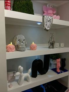 a shelf with candles and skulls on it