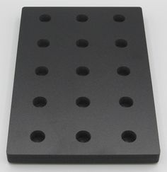 a black plastic board with holes in it