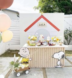 a charlie the snoopy birthday party with balloons and decorations on display in front of a house