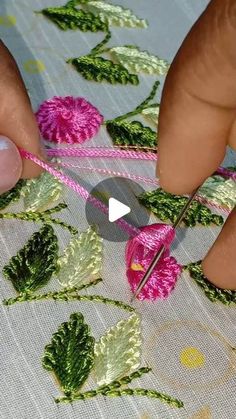 someone is doing something with yarn and scissors on the tablecloth that they are working on