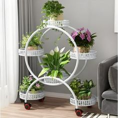 three tiered plant stand with potted plants on wheels