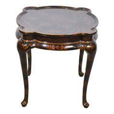 an ornately decorated wooden table with glass top