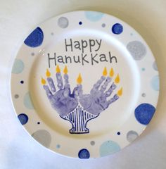 a white plate with blue and yellow designs on it that says happy hanukkah