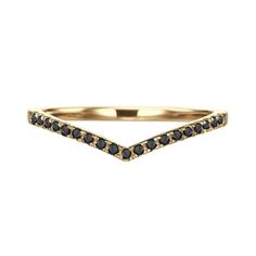 a gold ring with black diamonds on it