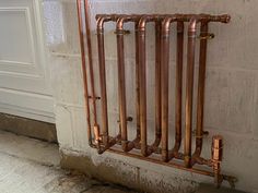 an old radiator with copper pipes attached to it