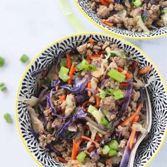 two bowls filled with meat and veggies on top of a white countertop