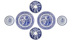 four blue and white plates sitting on top of each other