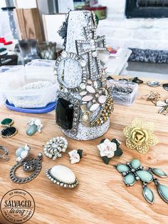 a table topped with lots of jewelry on top of it