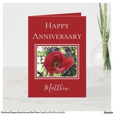 a red card with the words happy anniversary written on it and a photo of a flower