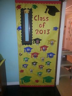 a door decorated with graduation caps and tassels for the 2013 class of graduates