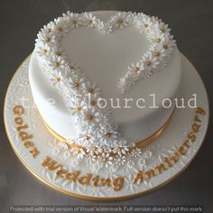 a wedding anniversary cake decorated with daisies