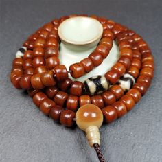 ❤This mala was made by Tibetan craftsmen and come from Hepo Town, Baiyu County, the birthplace of the famous Tibetan handicrafts.It is made of yak bone, brown color,108 dice beads diameter of 10mm / 0.4",circumference is 84cm / 33",and 3 dzi beads,end of a yak horn guru bead.❤DETAILS100% HandmadeMaterial:yak bone,yak horn,dzi beadSize:Mala Circumference:84cm/ 33 inch108 × yak bone beads, size:10mm/ 0.4 inch1 × 3 eyes mandala dzi bead, size:15 × 12mm/ 0.6 × 0.47 inch2 × tiger tooth dzi beads, siz Tibetan Yak, Lotus Sutra, Tiger Tooth, Buddhist Teachings, Om Mani Padme Hum, 3rd Eye, Everything Is Possible, Bone Beads, Brown Color