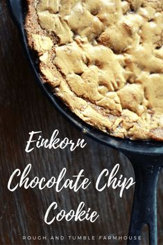 a chocolate chip cookie in a cast iron skillet on a wooden table with text overlay