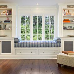 a living room filled with furniture and lots of windows