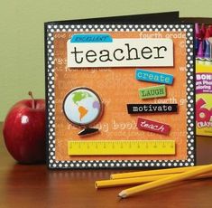 a teacher's desk with an apple and pencils