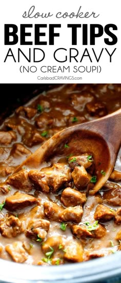 beef tips and gravy in a crock pot with a wooden spoon on the side